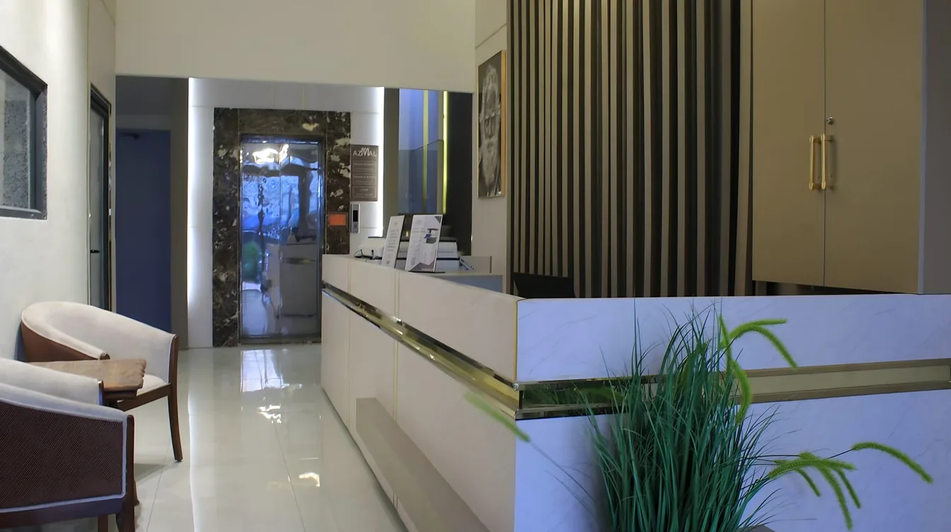 Reception and lobby at Azmal Hotel & Suites, Irbid, with the AZMAL plaque